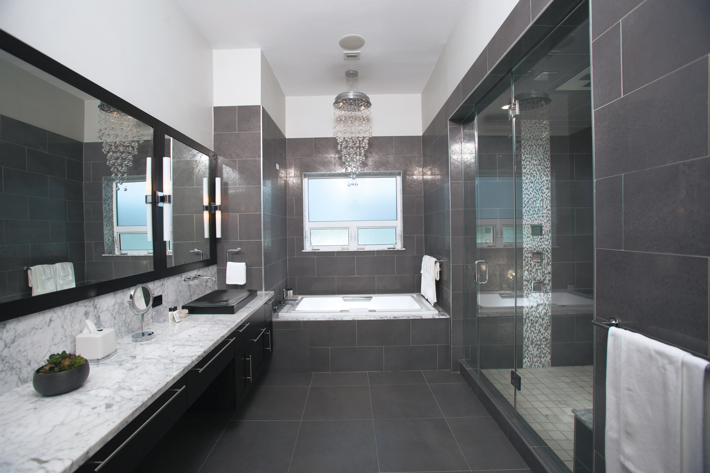 A steamroom on the right adds extra luxury in this master bathroom.