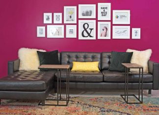 Cool City Design Sofa cushions and two small tables, with dark magenta wall behind it with pictures aquotes in frames